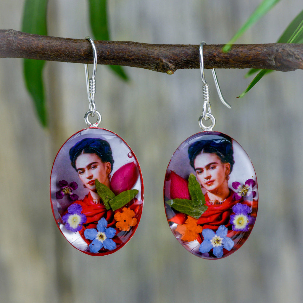 san marco silver and resin pendant earrings featuring a photograph of frida kahlo wearing a scarlet scarf adorned with colourful dried flowers