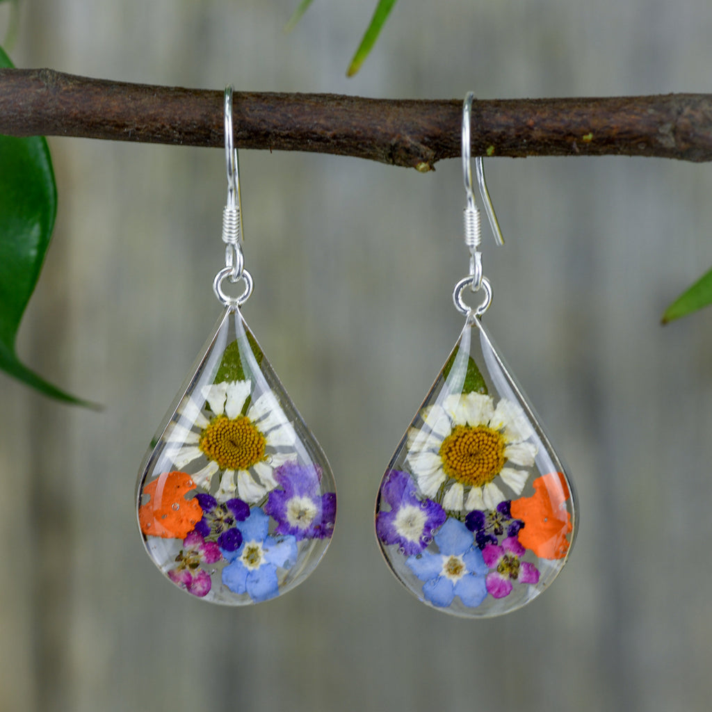 san marco medium length teardrop shaped silver and resin earrings with various coloured dried flowers encased in the resin