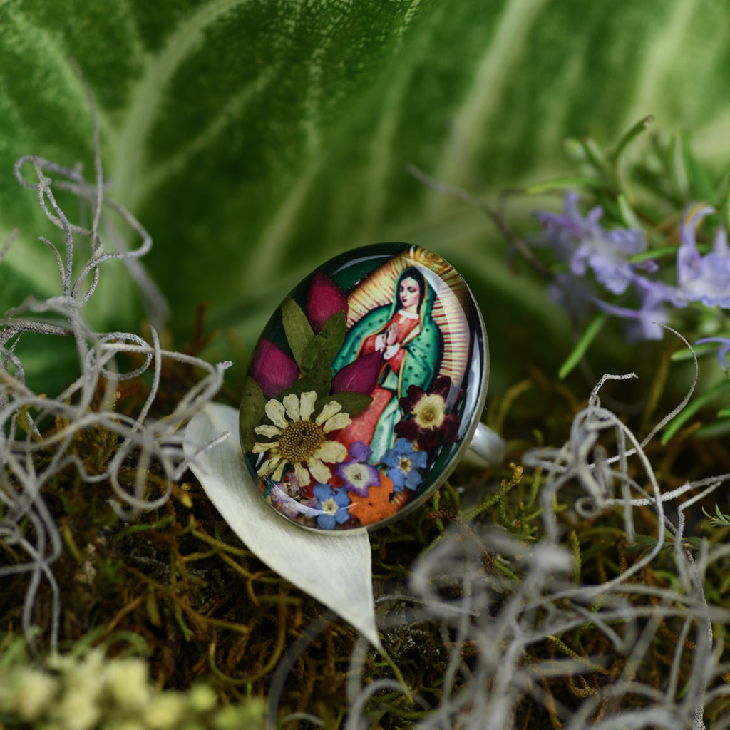 san marco silver and resin adjustable ring with picture of the virgin of guadalupe adorned with colourful dried flowers set in resin