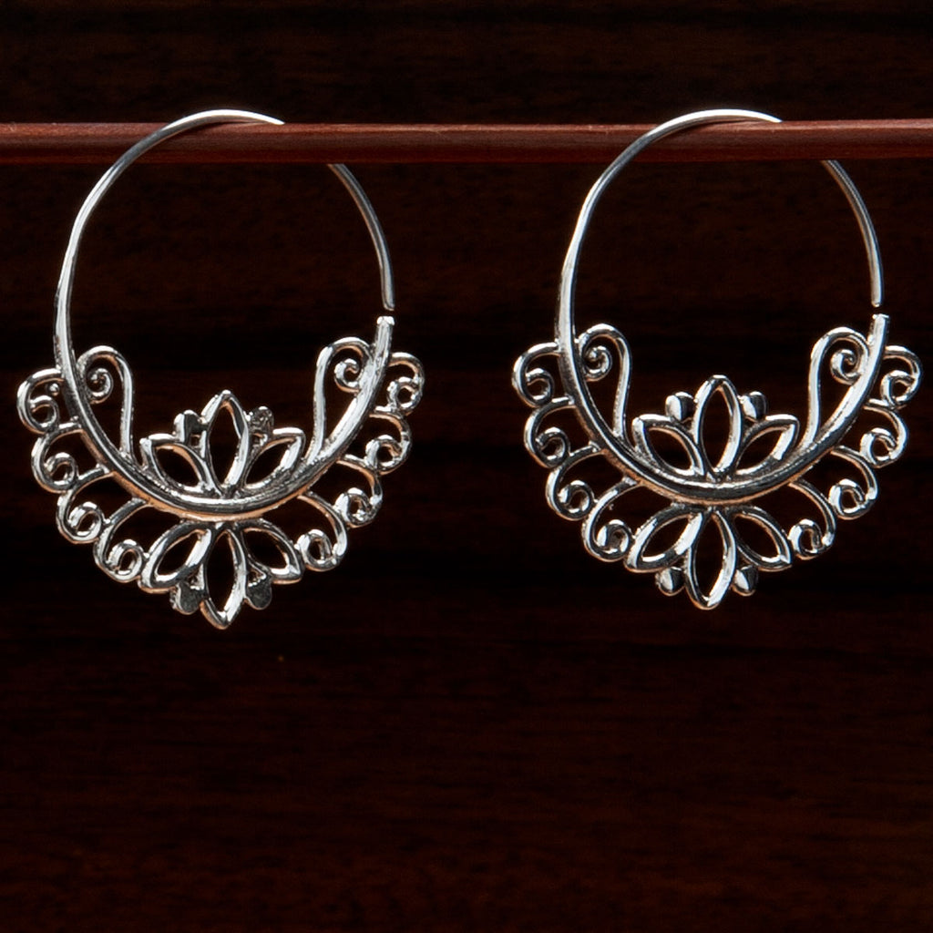 sterling silver lotus hoop earrings with ornate lotus motif on the inside and outside of the hoop