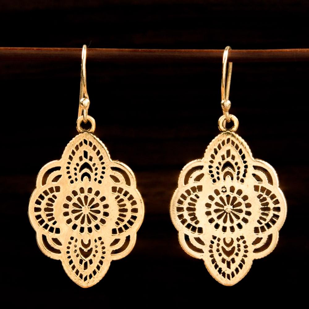 brass earrings with graphic floral design