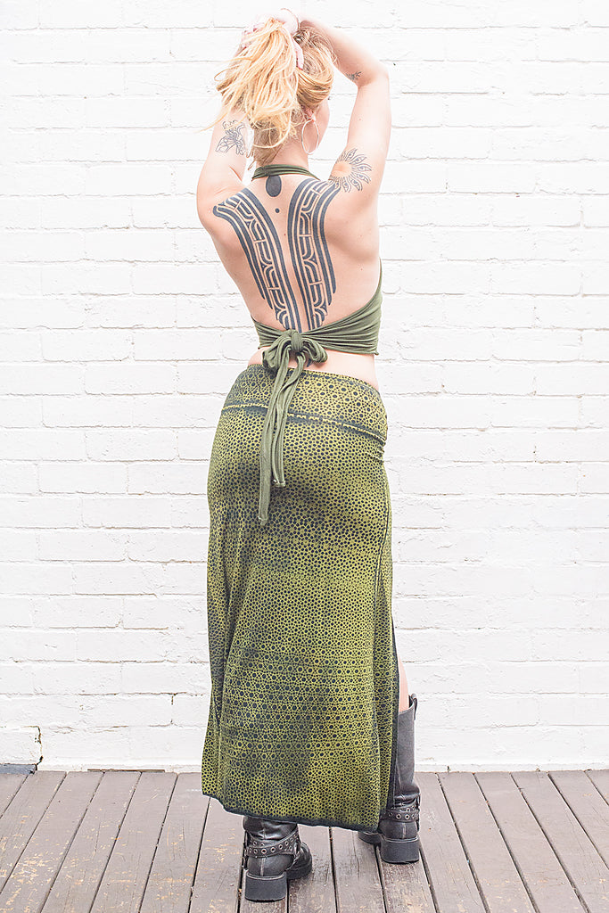 model wearing an autumn green sacred geometry print Aja long skirt from back