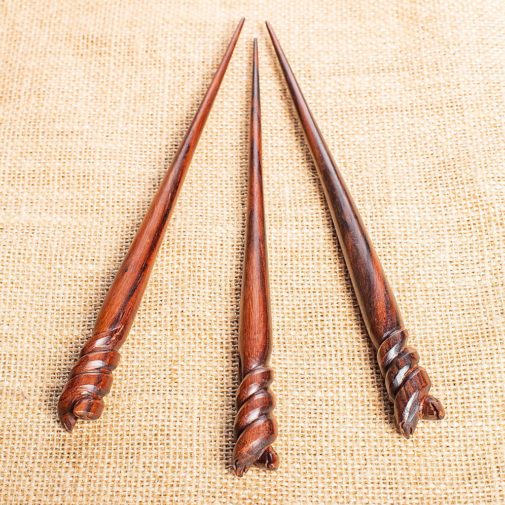 slender conical hair stick carved with braided helix design