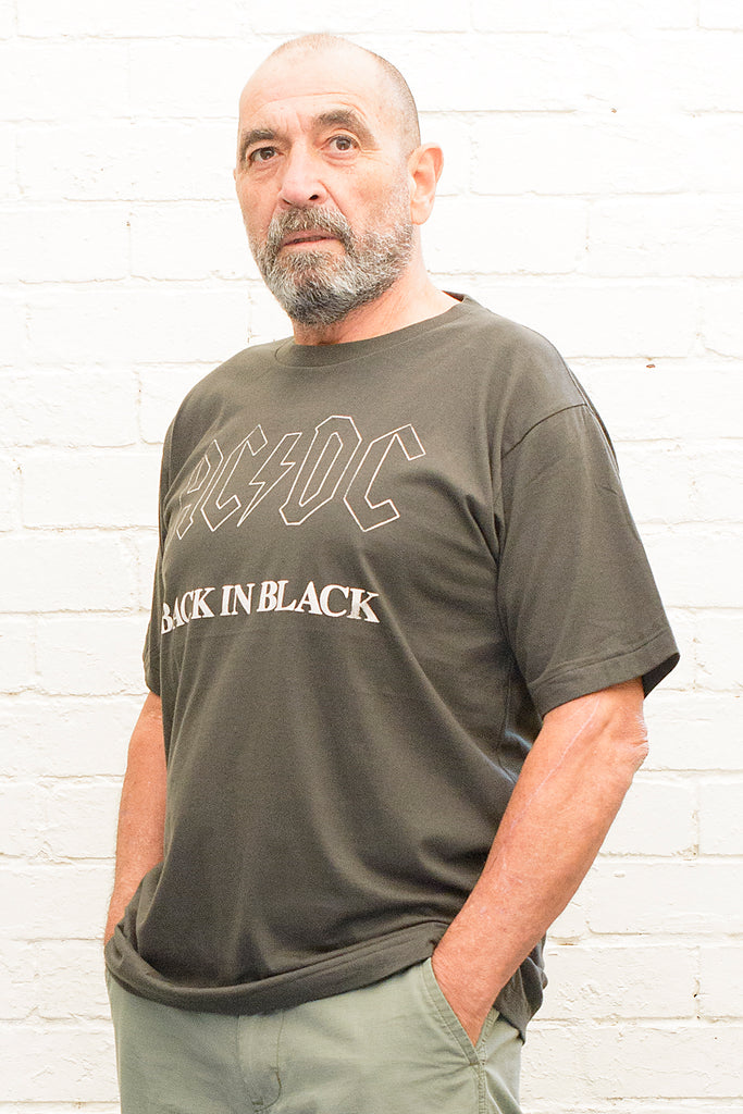 model wearing black cotton t-shirt with ac/dc back in black print on front