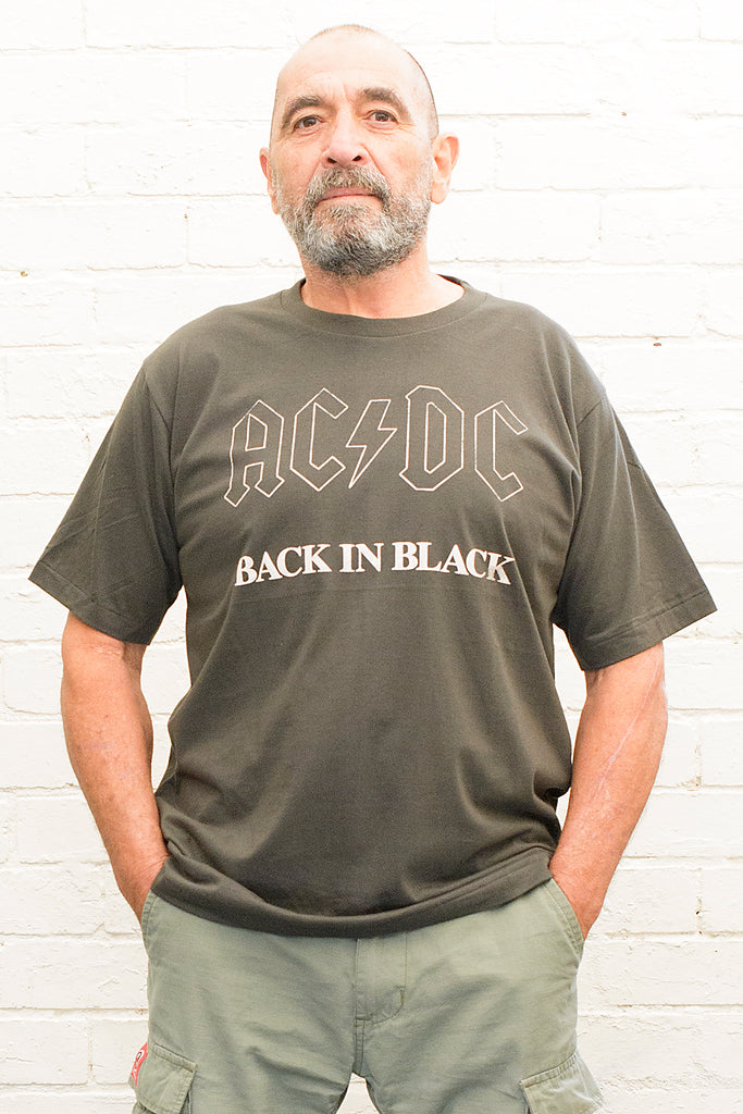 model wearing black cotton t-shirt with ac/dc back in black print on front