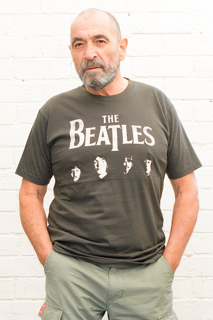 model wearing black cotton t-shirt with the beatles logo and band member portraits print on front