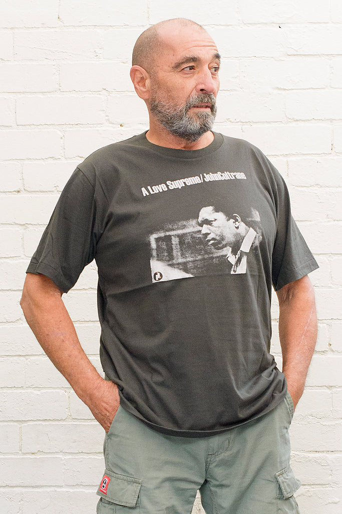 model wearing black cotton t-shirt with john coltrane a love supreme album cover print on front