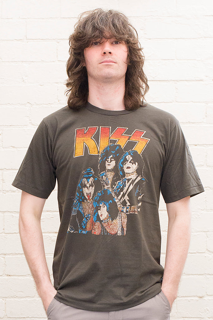 model wearing black cotton t-shirt with kiss logo and image of band members printed on front