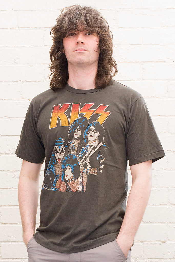 model wearing black cotton t-shirt with kiss logo and image of band members printed on front