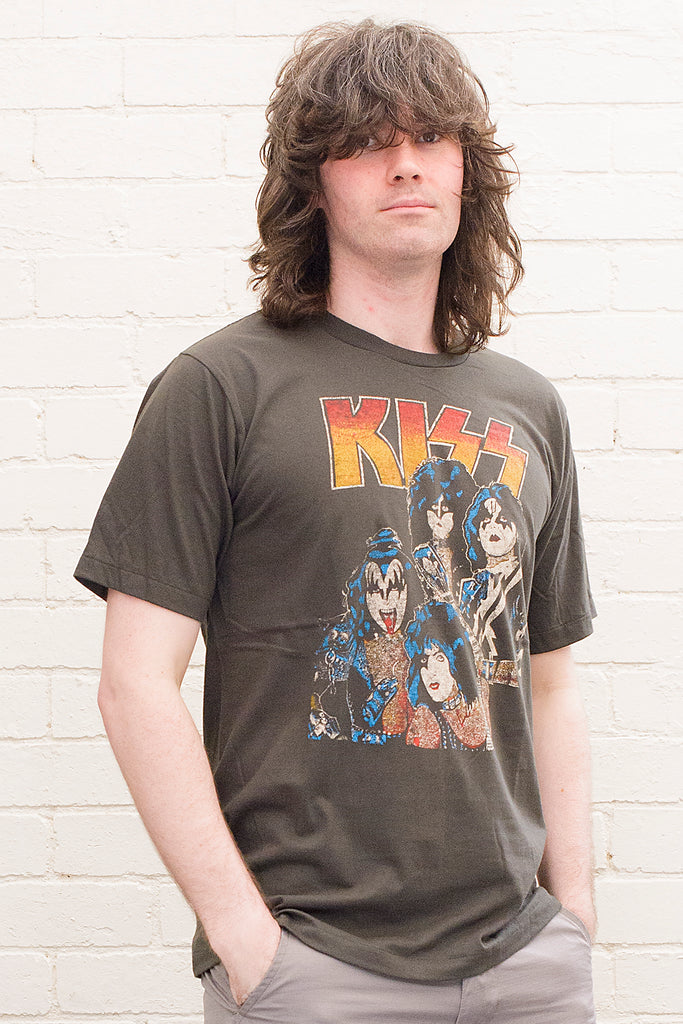 model wearing black cotton t-shirt with kiss logo and image of band members printed on front