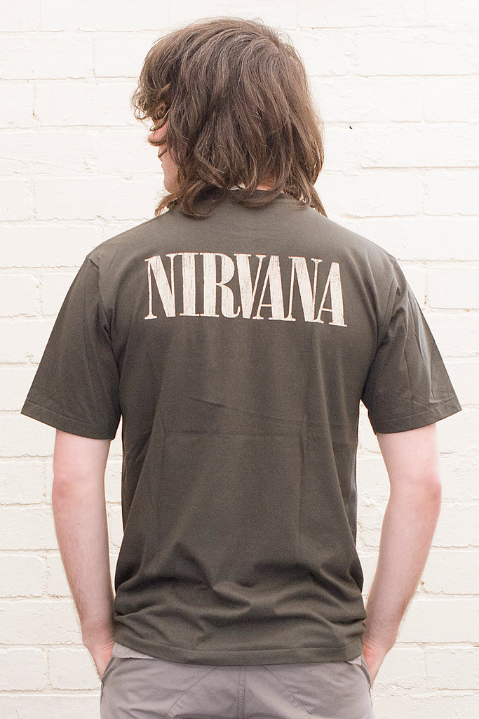 model wearing black cotton t-shirt with Nirvana logo printed on back