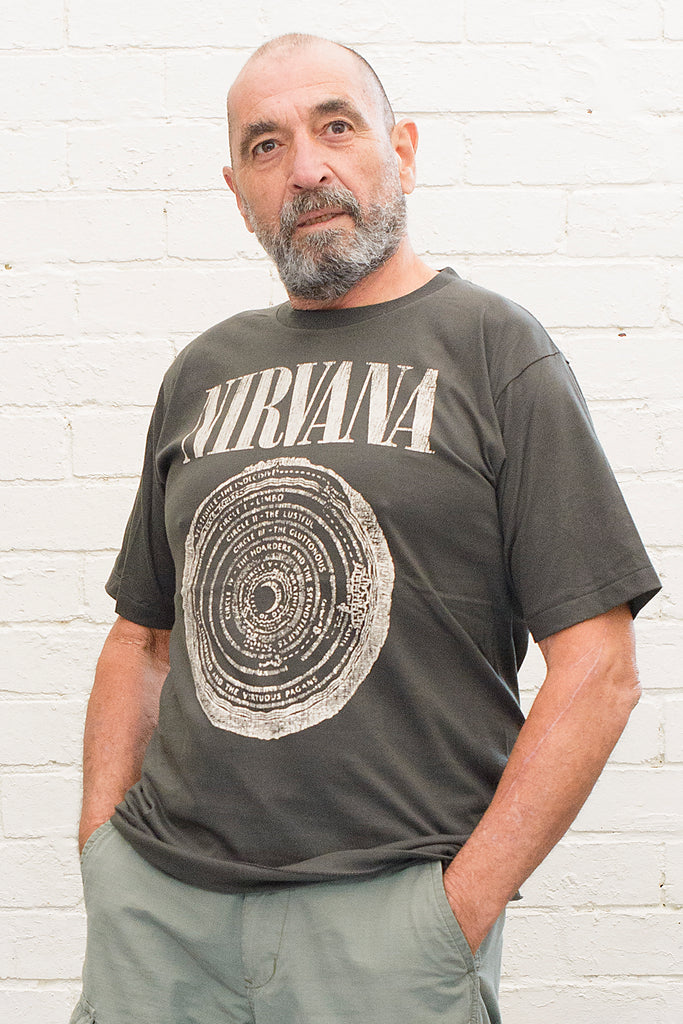 model wearing black cotton t-shirt with Nirvana logo and circle of hell graphic printed on front