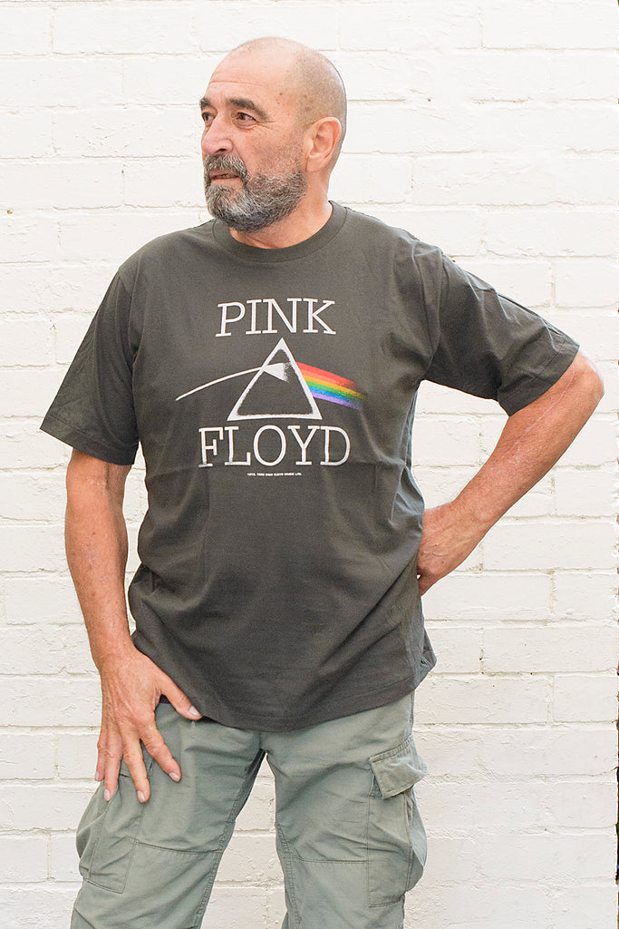 model wearing black cotton t-shirt with Pink Floyd Text and dark side of the moon refracting prism album cover artwork printed on front