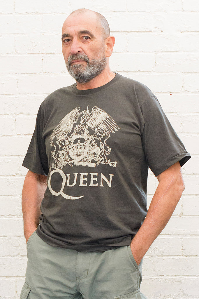 model wearing black cotton t-shirt with Queen crest and band name printed on front