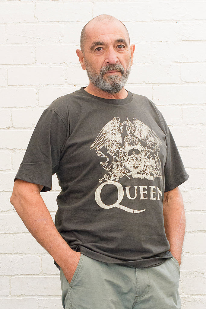 model wearing black cotton t-shirt with Queen crest and band name printed on front