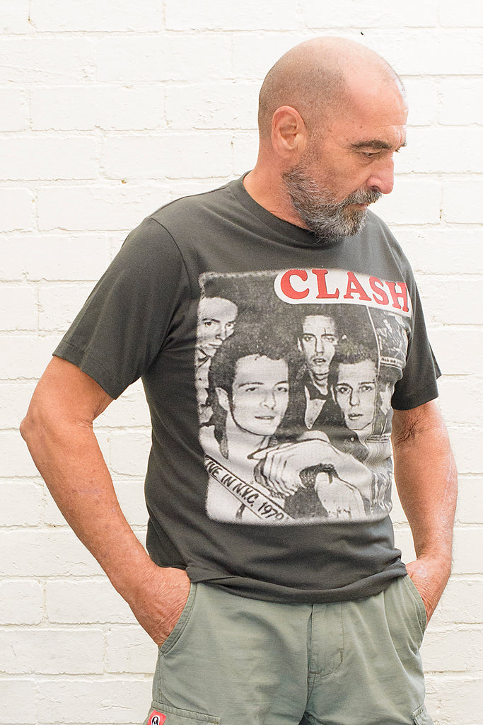 model wearing black cotton t-shirt with the clash lettering printed atop photographic images of the band in album cover format front