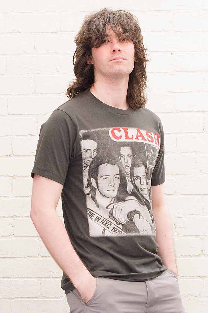 model wearing black cotton t-shirt with the clash lettering printed atop photographic images of the band in album cover format front