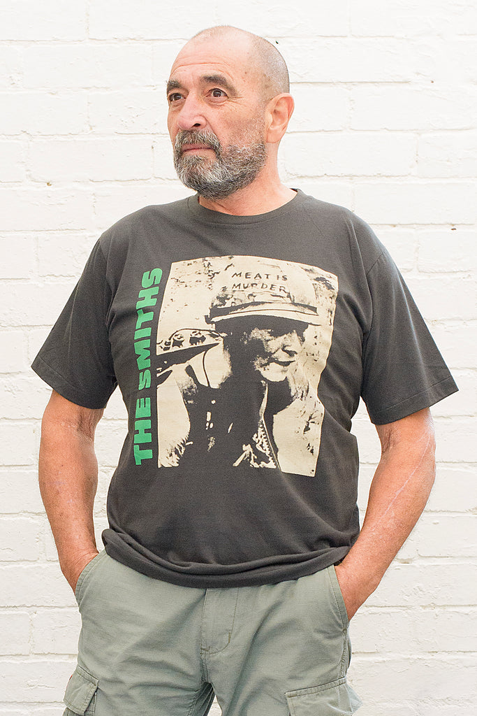 model wearing black cotton t-shirt with the smiths meat is murder album cover printed on the front