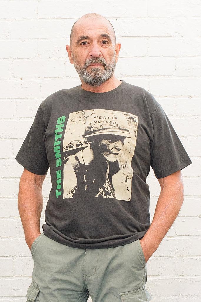 model wearing black cotton t-shirt with the smiths meat is murder album cover printed on the front