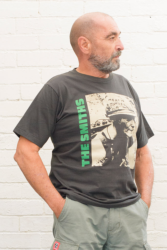 model wearing black cotton t-shirt with the smiths meat is murder album cover printed on the front