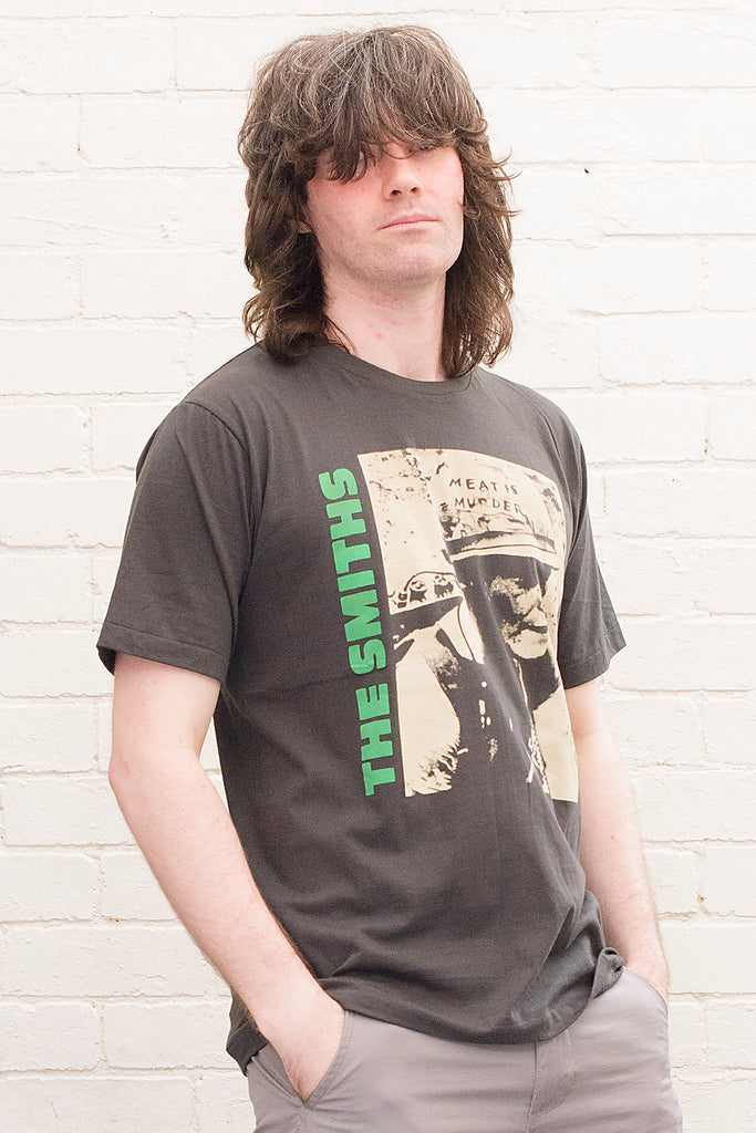 model wearing black cotton t-shirt with the smiths meat is murder album cover printed on the front