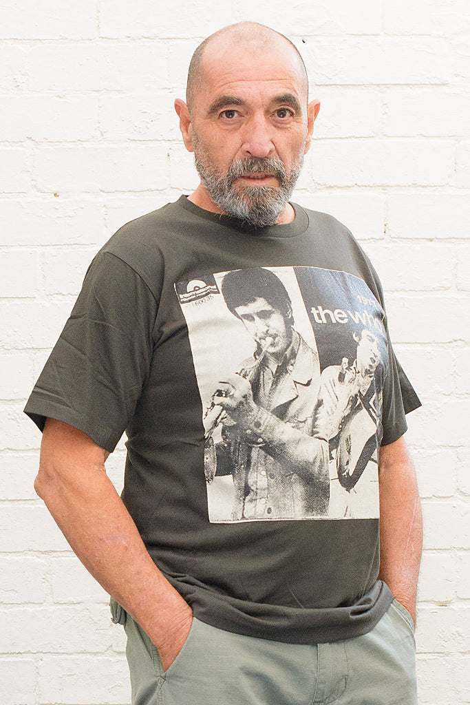 model wearing black cotton t-shirt with black and white photographs of the who and the text the who 1977 printed on the front