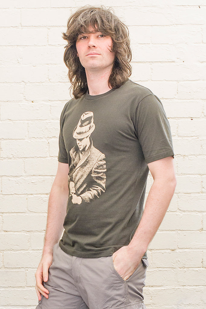 model wearing black t-shirt featuring a print of tom waits wearing a hat and overcoat on the front