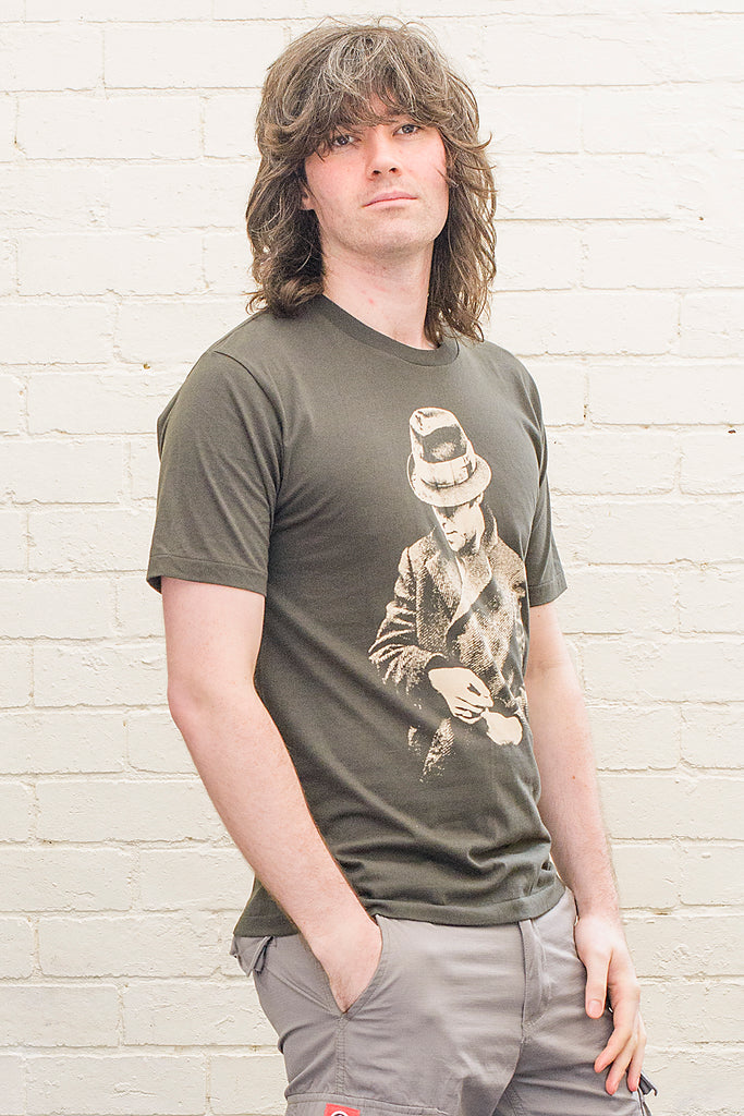 model wearing black t-shirt featuring a print of tom waits wearing a hat and overcoat on the front