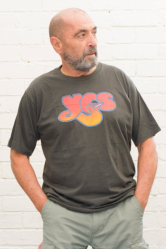 model wearing black t-shirt with the yes band logo printed on the front