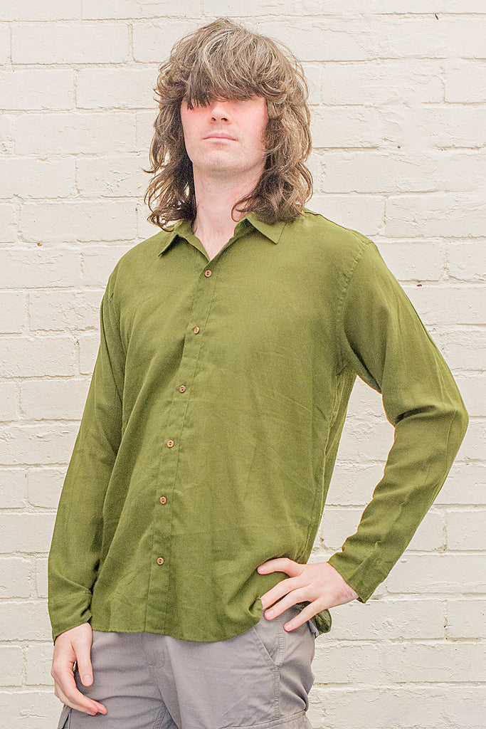 model wearing green cotton button up long sleeved collared shirt from the front