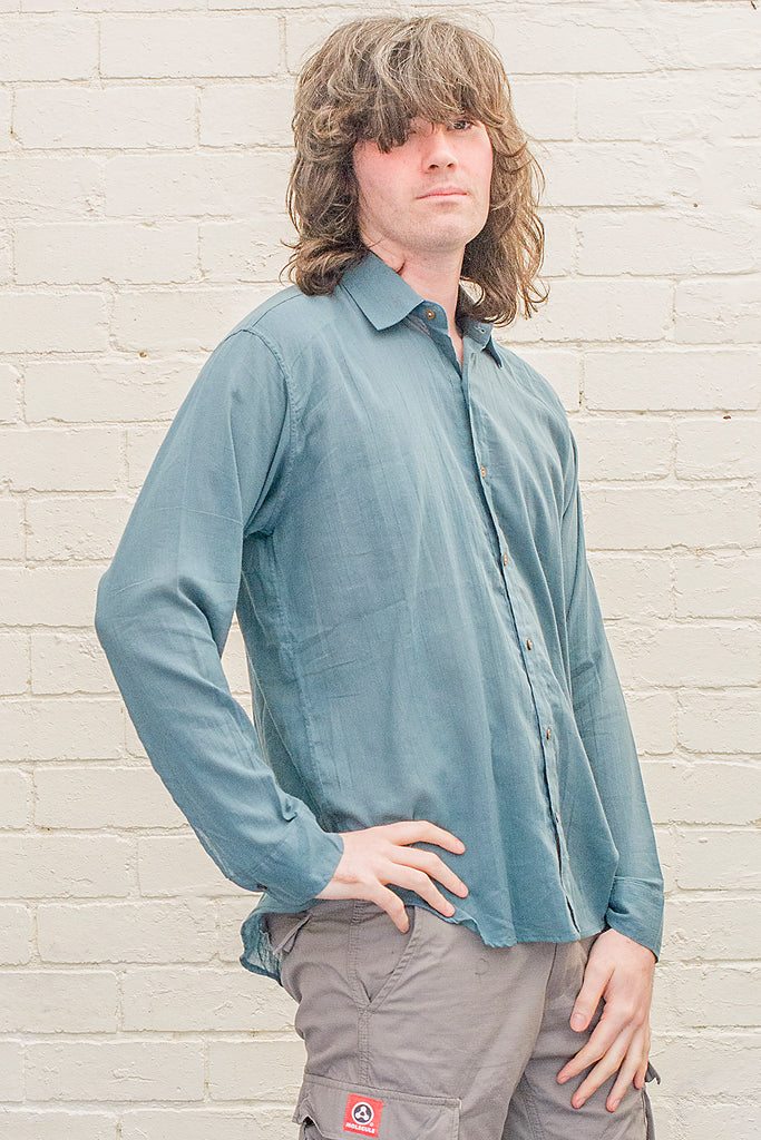 model wearing teal cotton button up long sleeved collared shirt from the front