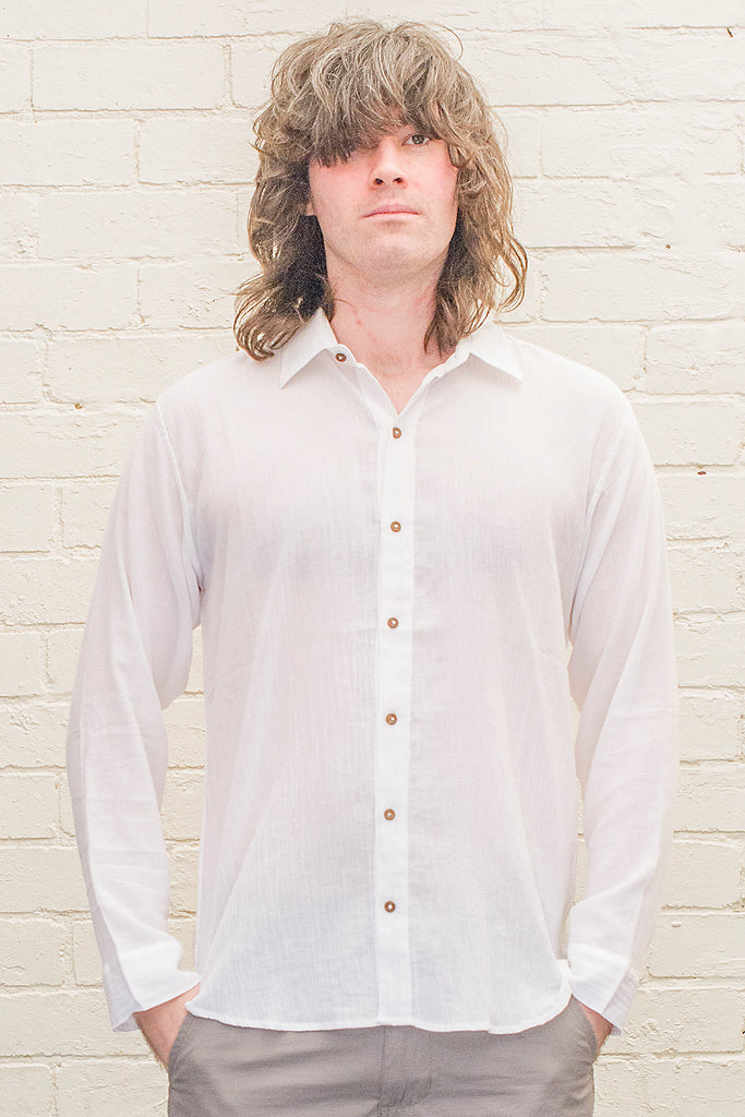 model wearing white cotton button up long sleeved collared shirt from the front