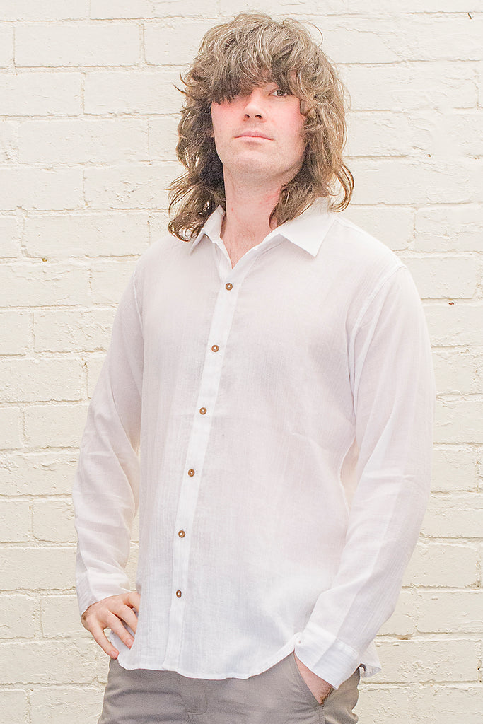 model wearing white cotton button up long sleeved collared shirt from the front