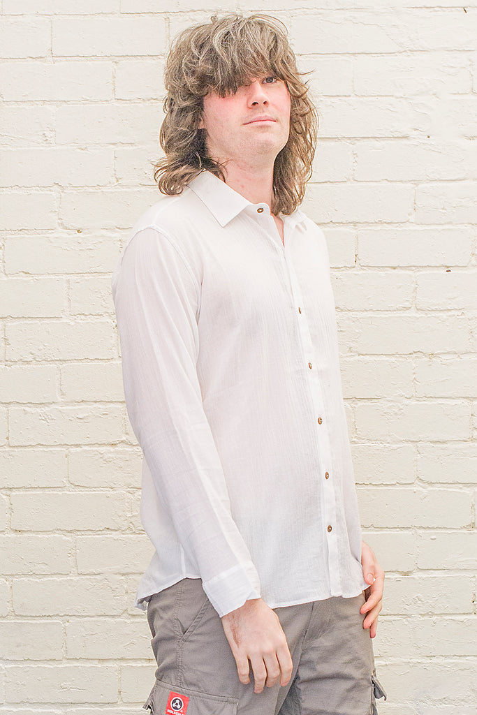 model wearing white cotton button up long sleeved collared shirt from the front