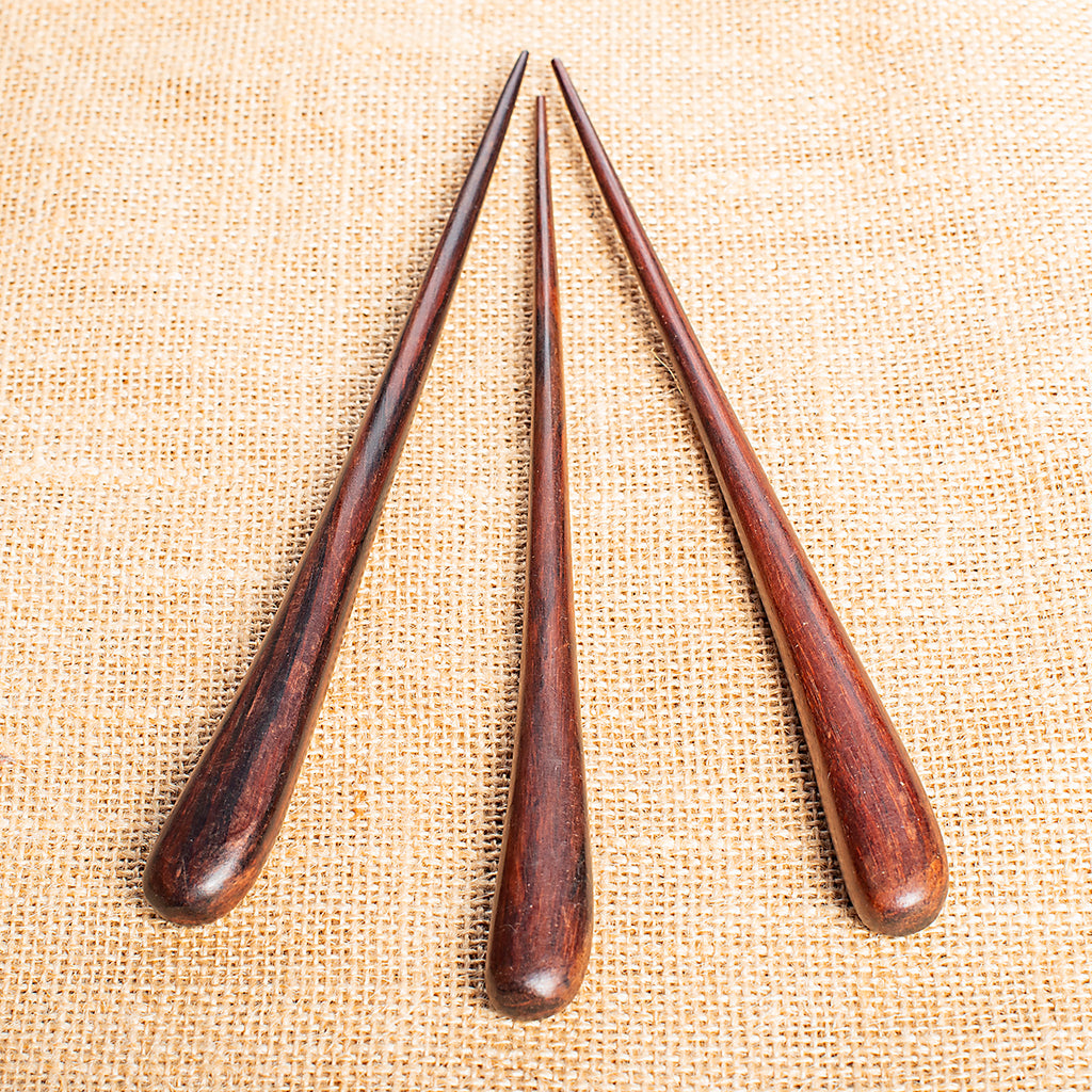 hand carved roughly conical slender droplet shaped hair stick with rounded end