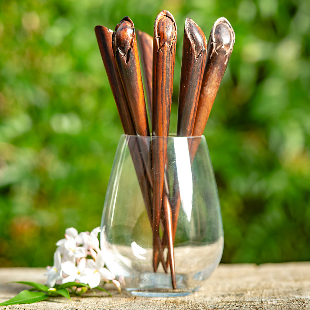 hand carved conical wooden hairstick with flower bud at end