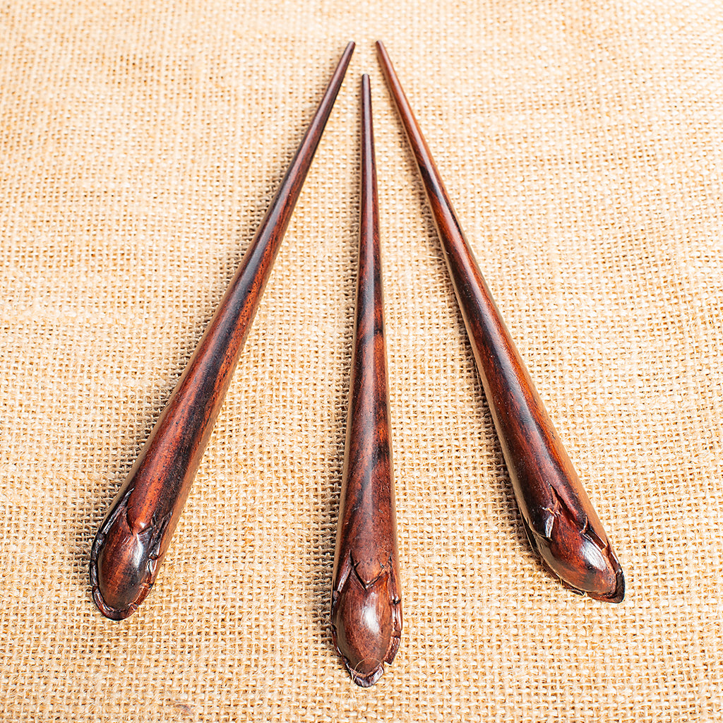 hand carved conical wooden hairstick with flower bud at end