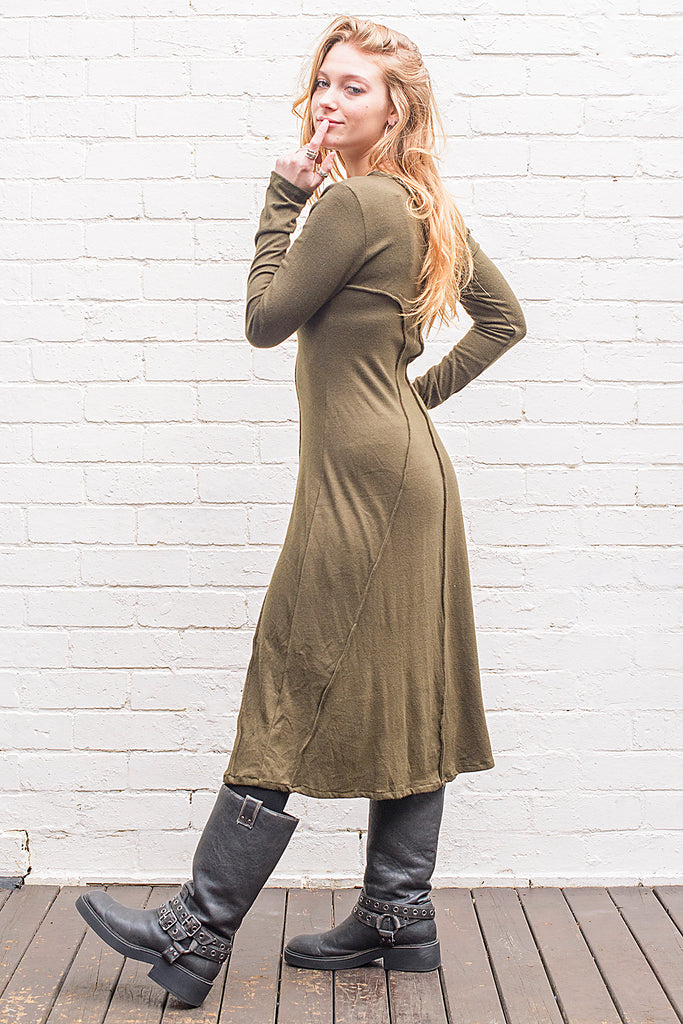 Model wearing a Marzanna midi length knit dress in army green from side