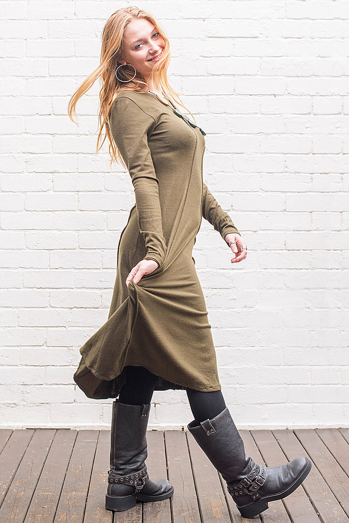 Model wearing a Marzanna midi length knit dress in army green from side