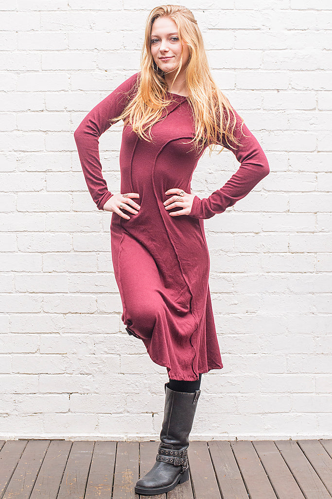 Model wearing a Marzanna midi length knit dress in maroon