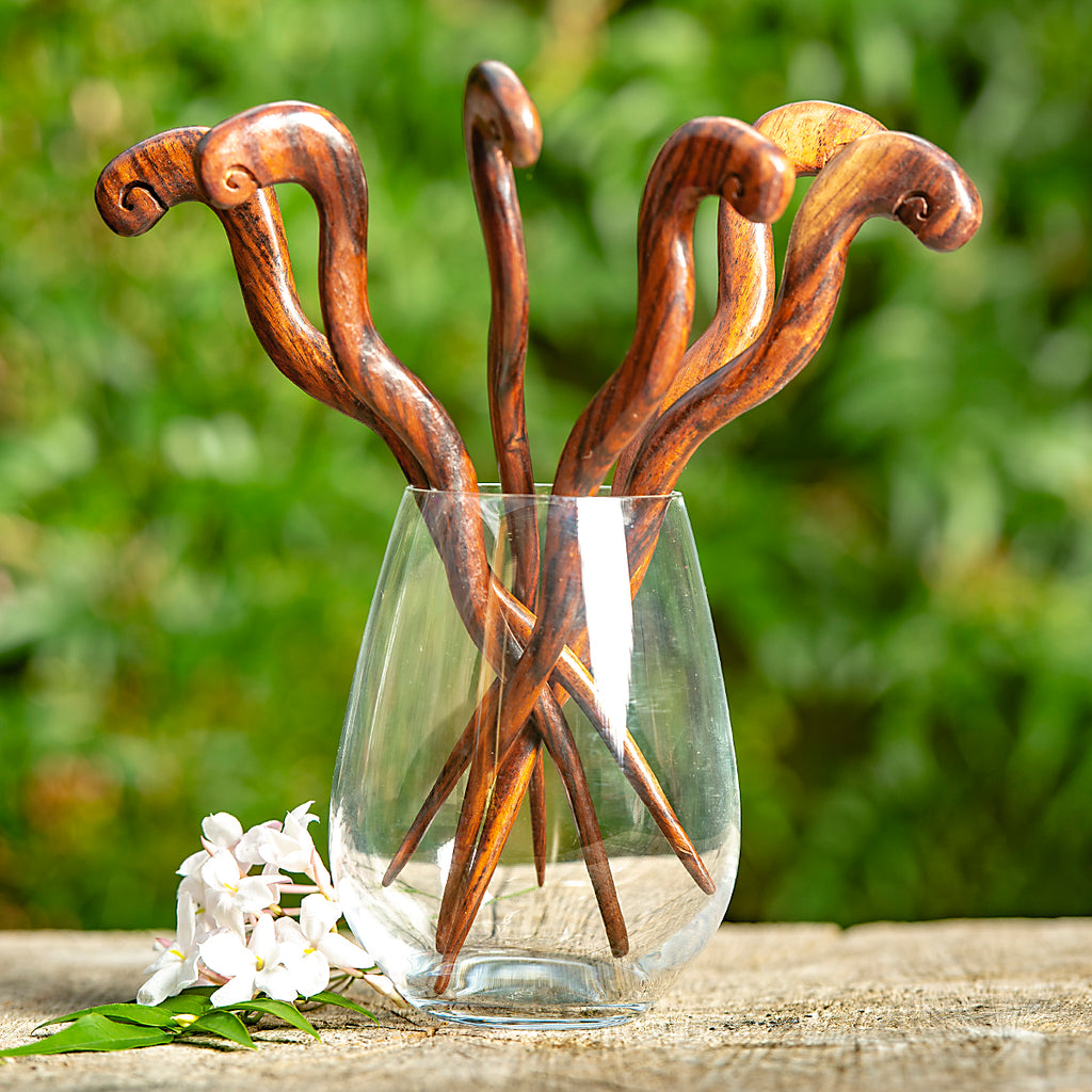 wooden hair stick naively carved to resemble a curly snake