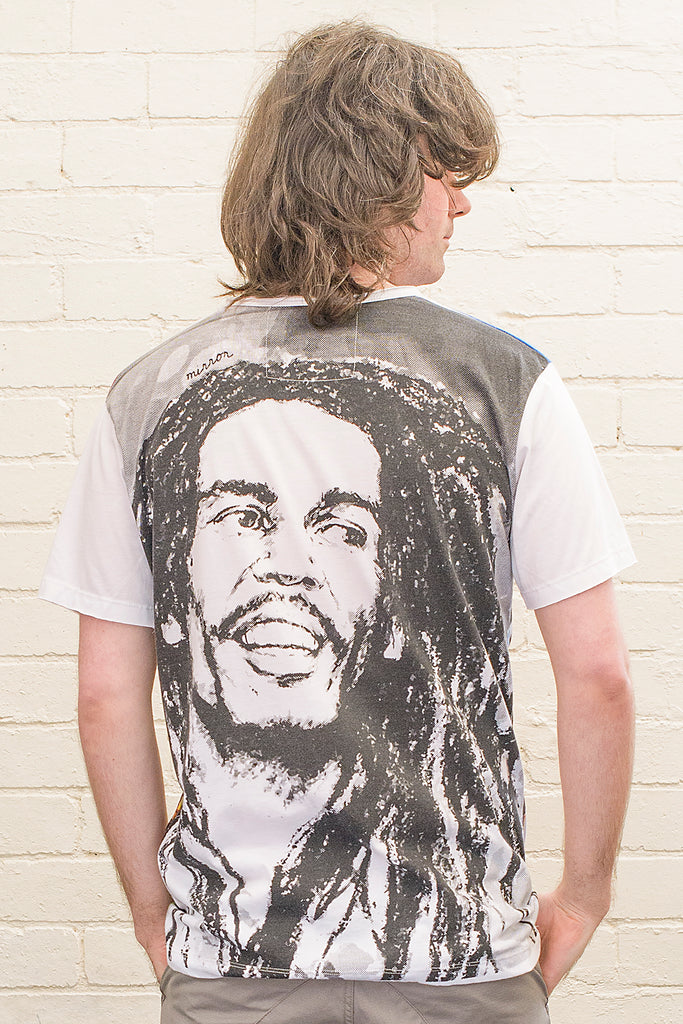 model wearing a white T-shirt with a black and white image of Bob Marley printed on the back