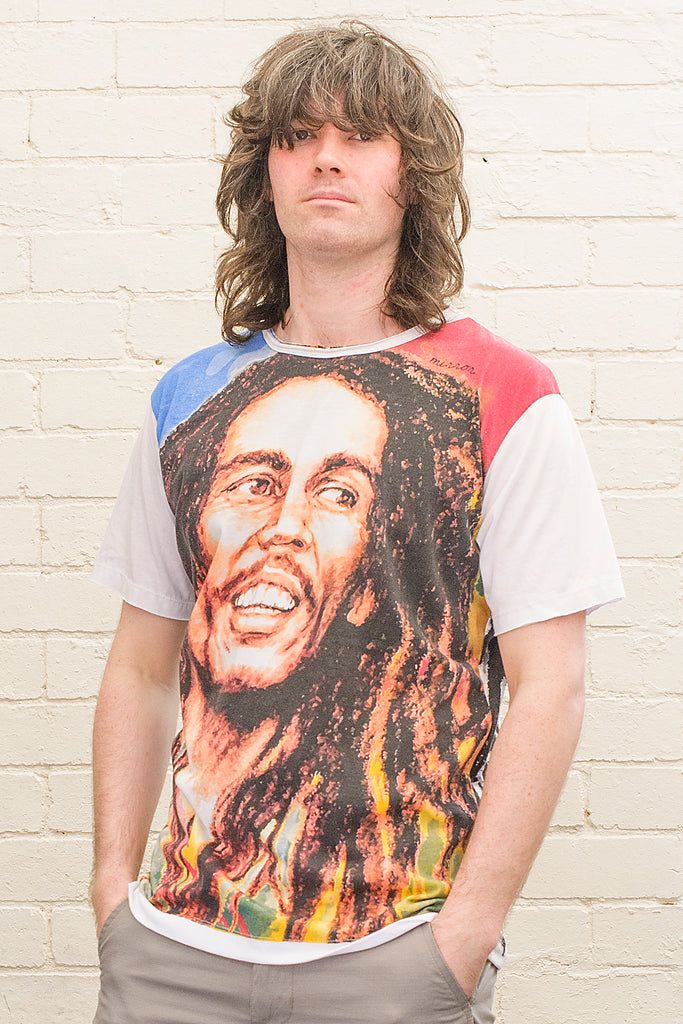 model wearing a white T-shirt with a colourful image of Bob Marley printed on the front