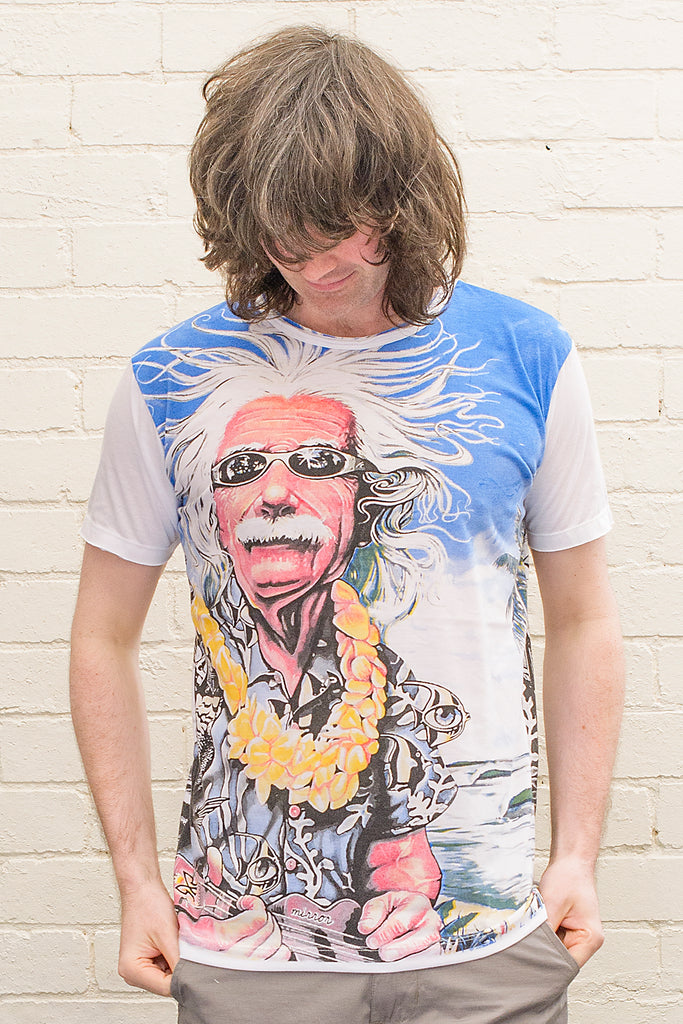 model wearing a white T-shirt featuring a colourful caricature of albert einstein wearing sunglasses a hawaiian shirt and flower lei whilst playing ukelele at the beach printed on the front