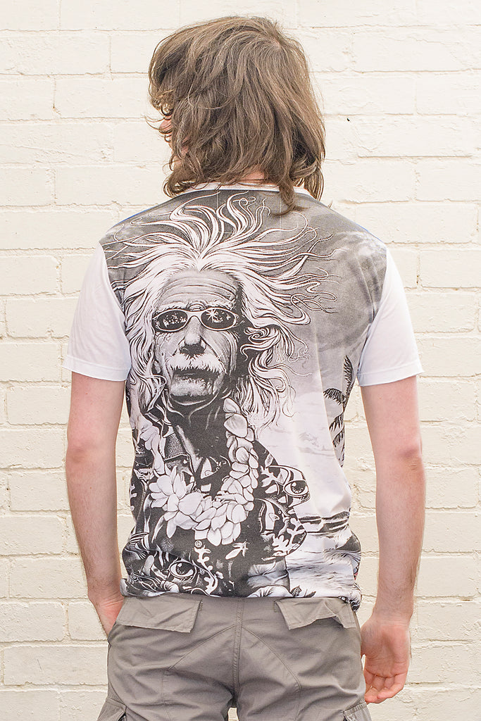 model wearing a white T-shirt featuring a black and white caricature of albert einstein wearing sunglasses a hawaiian shirt and flower lei at the beach printed on the back