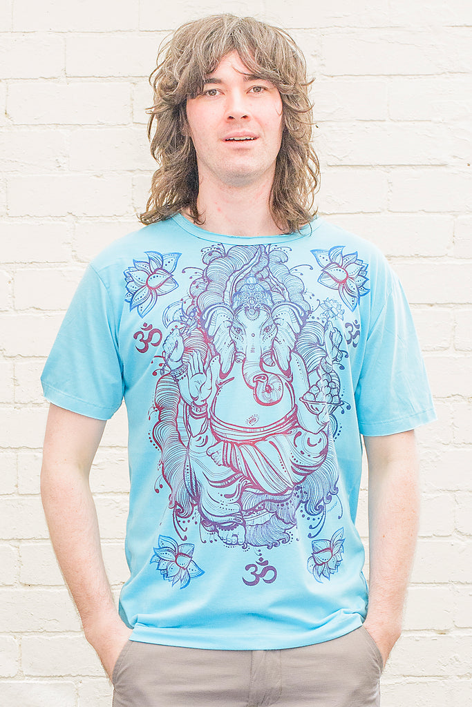 model wearing a bright blue T-shirt featuring a colourful ganesh line drawing design printed on the front in blue red and purple tones