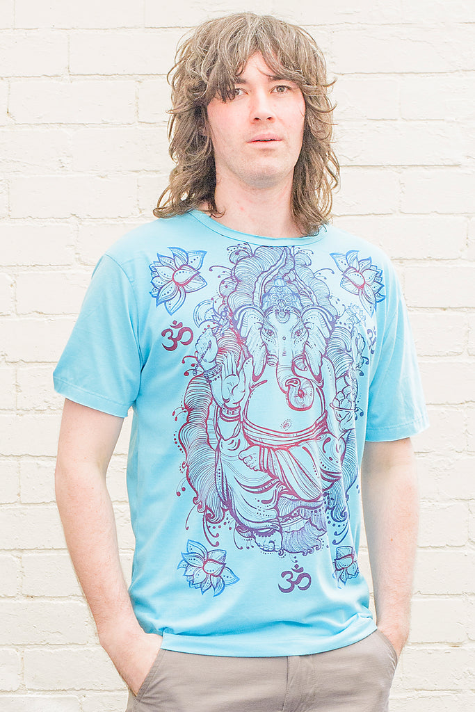 model wearing a bright blue T-shirt featuring a colourful ganesh line drawing design printed on the front in blue red and purple tones