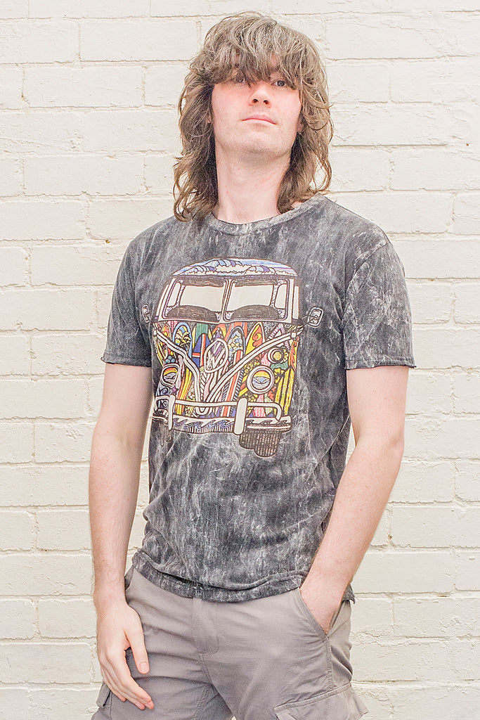 model wearing a black stonewash t-shirt printed with a colourful 1970s style doodle artwork of a split screen volkswagen kombi van with surf themed paintwork from the front