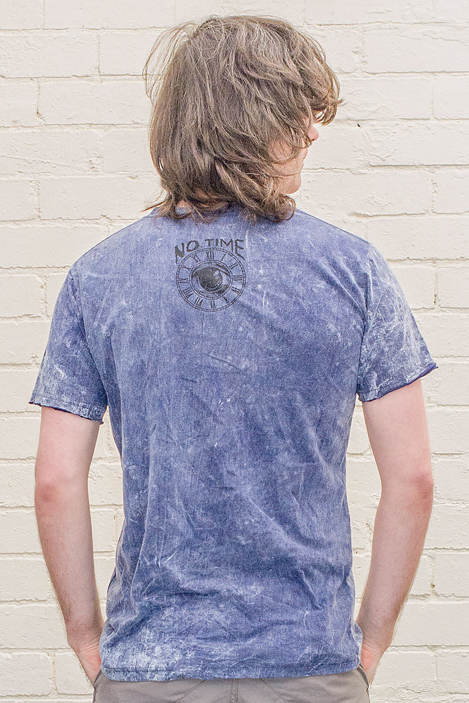 model wearing a dark blue stonewash t-shirt printed with the no time brand logo on the back