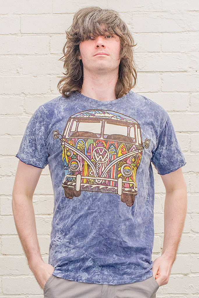 model wearing a dark blue stonewash t-shirt printed with a colourful 1970s style doodle artwork of a split screen volkswagen kombi van with surf themed paintwork from the front